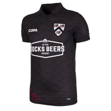Docks Beers x COPA Football Shirt in black, featuring a unique pattern, a polo collar, and the Docks Beers Grimsby sponsor logo.