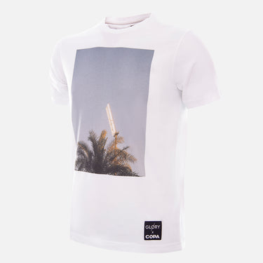 Front view of the Glory x COPA Floodlights & Palmtrees T-shirt, featuring a white design with a printed graphic of a floodlight and palm trees.