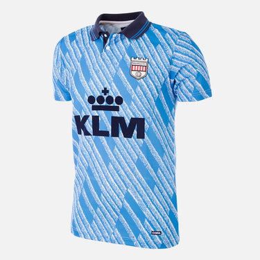 Flat lay of the Brentford FC 1992-94 Away Retro Football Shirt in sky blue with a subtle chevron pattern and KLM sponsor logo.