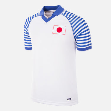 Flat lay of the Japan 1987 - 88 Retro Football Shirt, featuring a white base with blue striped sleeves and a Japanese flag emblem.