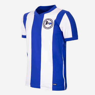 Flat-lay of the Arminia Bielefeld 1964-65 Retro Football Shirt, featuring blue and white vertical stripes.