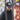 Man wearing a black "AWAY DAYS" COPA trucker cap standing near a graffiti wall