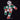 Close-up of the Ciao mascot print, showing its geometric body in green, white, and red, holding a football on the black fabric.