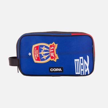 Front view of the recycled toiletry bag featuring a repurposed football shirt with a Newcastle Jets badge and COPA logo