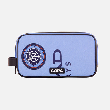Front view of the recycled toiletry bag featuring a repurposed football shirt with a New York City badge and COPA logo