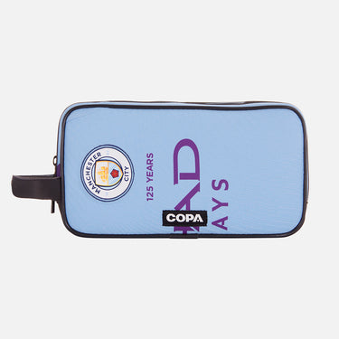 Front view of the recycled toiletry bag featuring a repurposed football shirt with a Manchester City badge and COPA logo