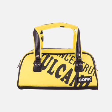 Flat-lay of the yellow Recycled Shopping Bag with abstract white graphic and black handles.