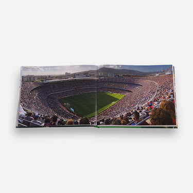 Double-page spread showing packed stadium with crowd and pitch view