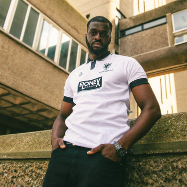 Model wearing the shirt in an outdoor urban setting, showcasing its fit and design.