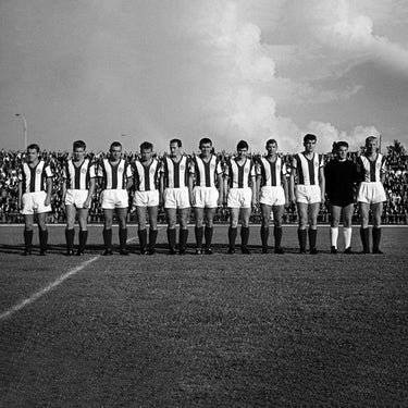 Vintage team photo of Arminia Bielefeld players lined up on the pitch.