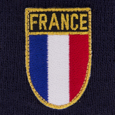 Embroidery detail of the France crest with blue, white, and red vertical stripes outlined in gold
