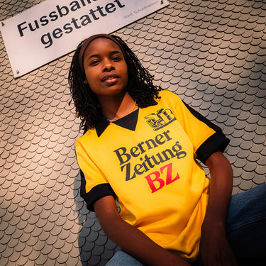 BSC Young Boys 1980 - 81 Retro Football Shirt Yellow & Black Lifestyle worn by a model in an urban setting.
