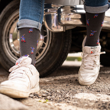 model wearing casual grey socks with a repeating pixel-style illustration of iconic football moment france 2000