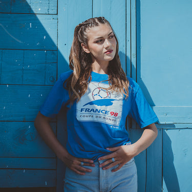 Model wearing the France 1998 World Cup Emblem T-Shirt in a casual setting.