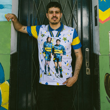 Model wearing the Maradona x COPA bootleg shirt, featuring Boca Juniors legends in a vibrant retro design.