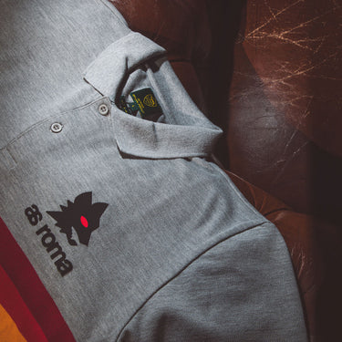 Close-up of polo worn outdoors, highlighting crest and fabric texture.
