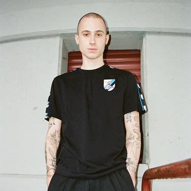 FC Internazionale Taper T-Shirt Black Lifestyle worn by a model in a modern, minimalist indoor setting.
