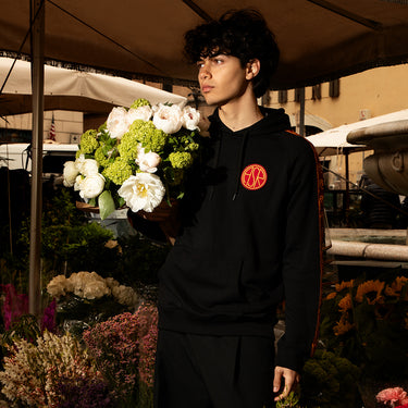 Model wearing the AS Roma Black Taper Hooded Sweater standing outdoors