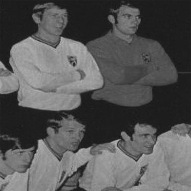 Historic black-and-white image of Belgian football players in action, wearing vintage kits.