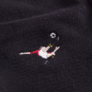 Close-up of embroidered Panini overhead kick graphic on black fabric