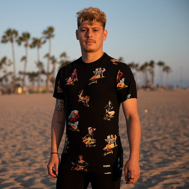 Model wearing the Calcio Donna T-Shirt on a sandy beach, showcasing the fit and design in an outdoor setting.