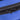 Close-up of black zipper stitched into vibrant blue fabric.